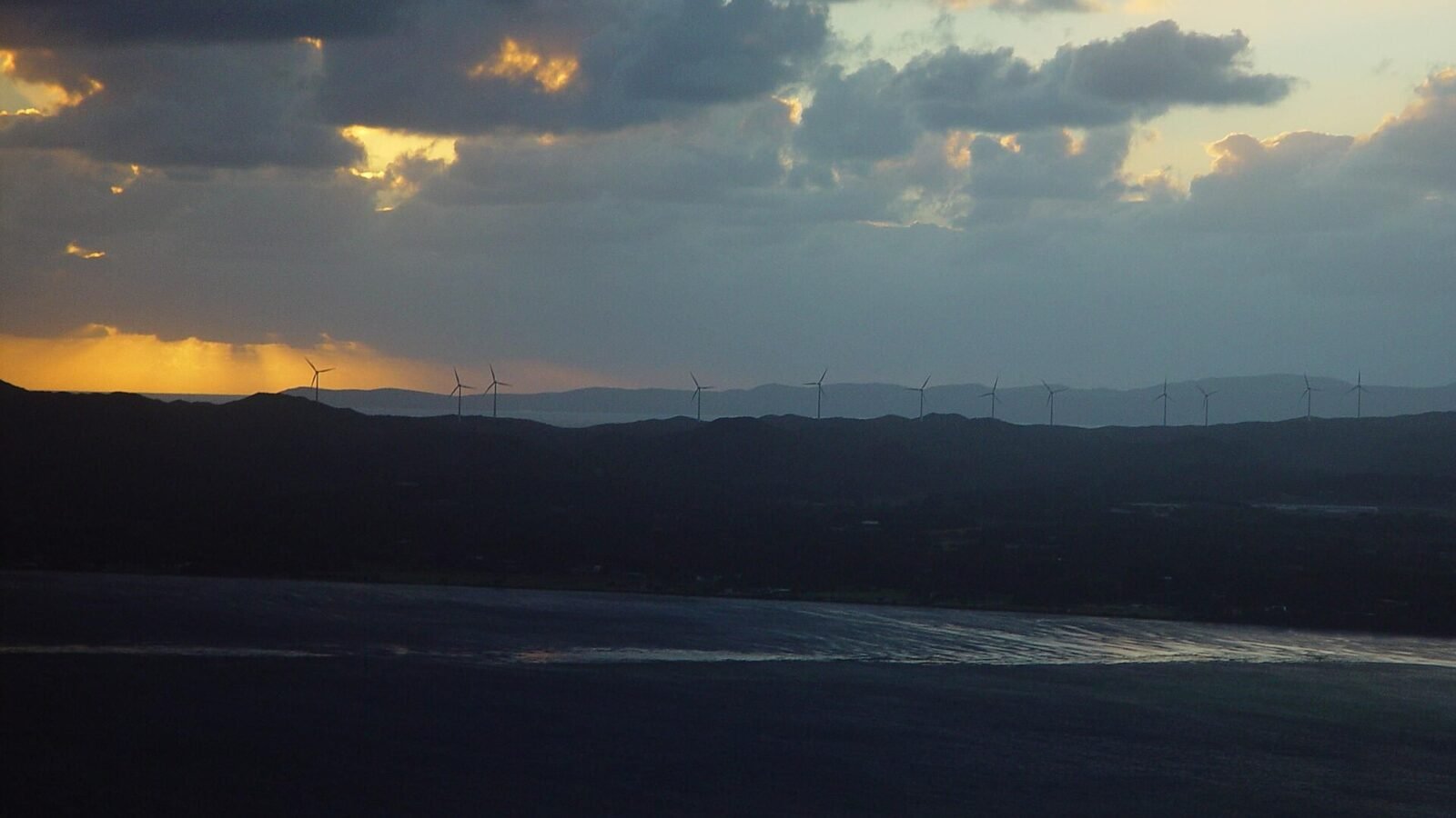 Thematic lead image: wind turbines, energy infrastructure — Trump Administration's $1.2 Billion Wind Project Cancellation Raises Subsidy Questions | National Times