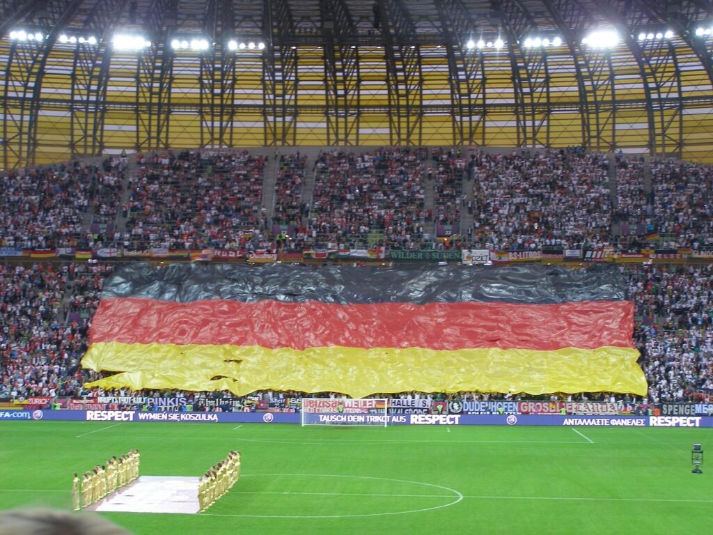 Thematic lead image: football stadium, flags — Poland's U20 Women's World Cup Bid Navigates UEFA-FIFA Rift | National Times