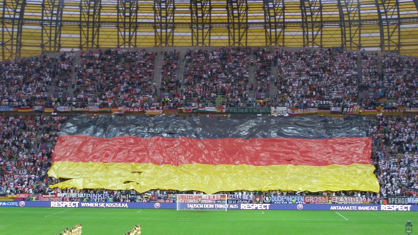 Thematic lead image: football stadium, flags — Poland's U20 Women's World Cup Bid Navigates UEFA-FIFA Rift | National Times