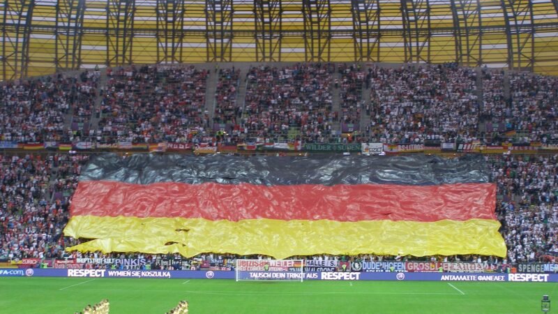 Thematic lead image: football stadium, flags — Poland's U20 Women's World Cup Bid Navigates UEFA-FIFA Rift | National Times