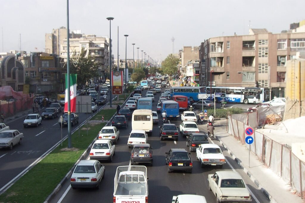 Thematic lead image: Iranian flag, government building — Iran's 'Colonialism' Claim: A Bid to Redefine Sanctions as Sovereignty Violations | National Times
