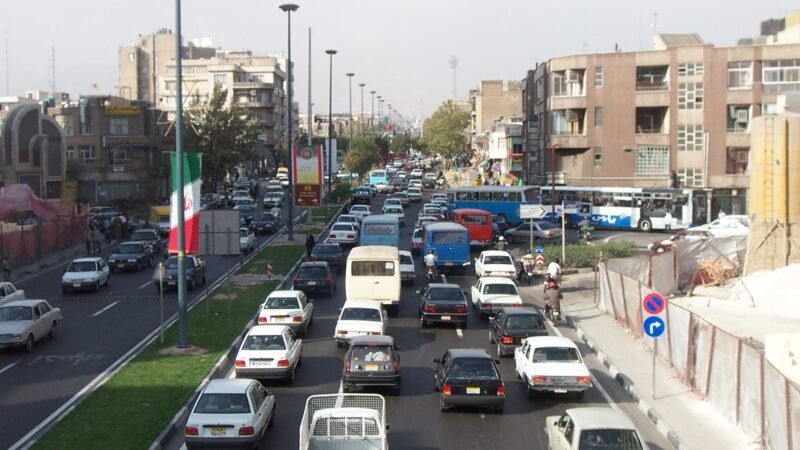 Thematic lead image: Iranian flag, government building — Iran's 'Colonialism' Claim: A Bid to Redefine Sanctions as Sovereignty Violations | National Times