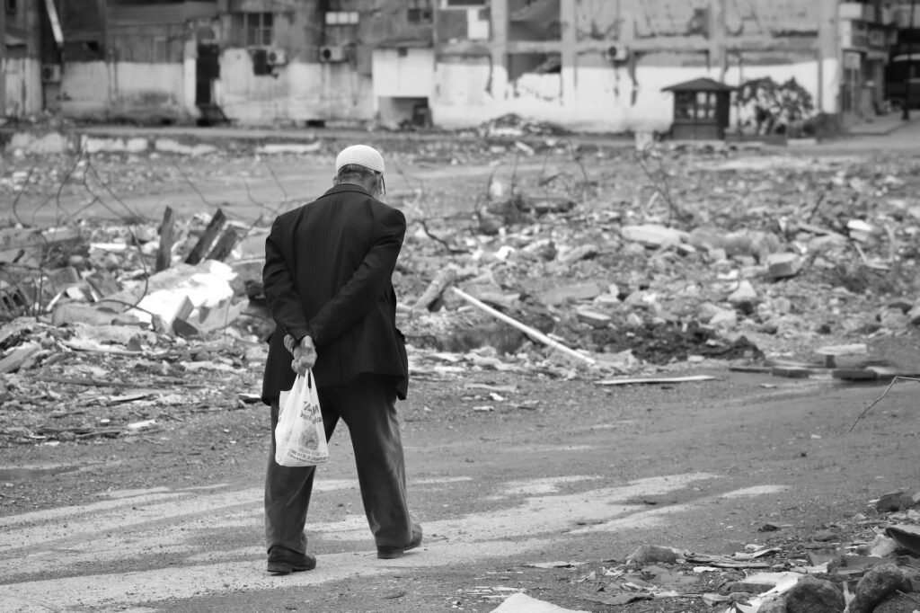 Thematic lead image: mass funeral amid rubble — Buried twice: what Gaza's 112 recovered bodies settle, and what they cannot | National Times