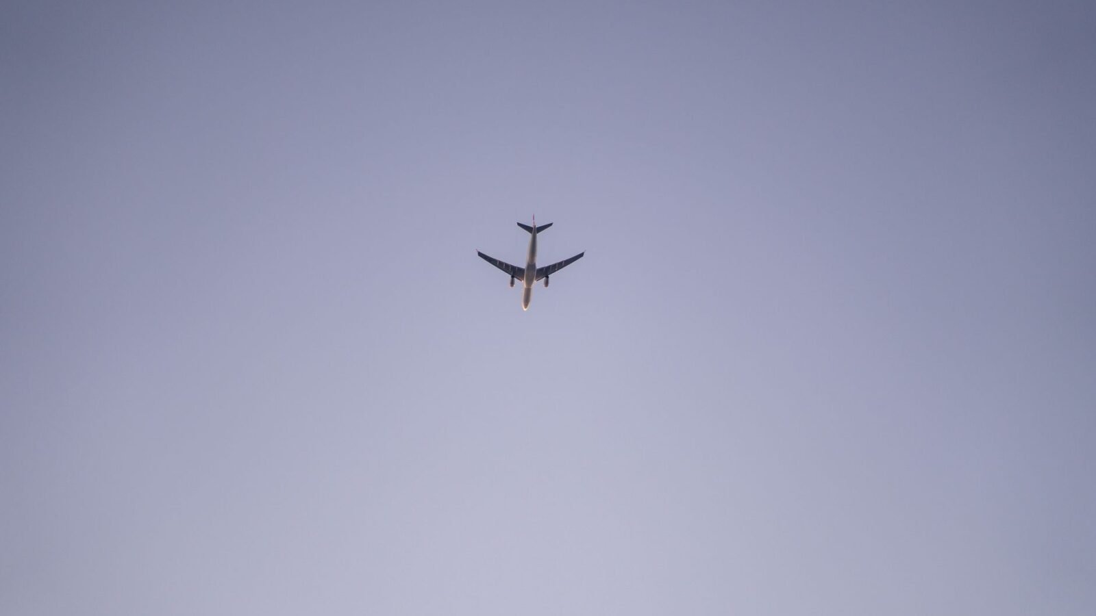 Thematic lead image: aircraft flying over stadium — South African Airlink Stunt Flying Divides Aviation Safety Debate | National Times