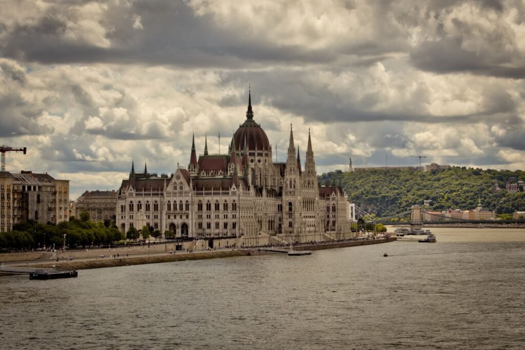 Thematic lead image: Hungarian Parliament Building, Forint currency — Hungary's Rate Cuts Challenge Orthodox Disinflation Playbook | National Times