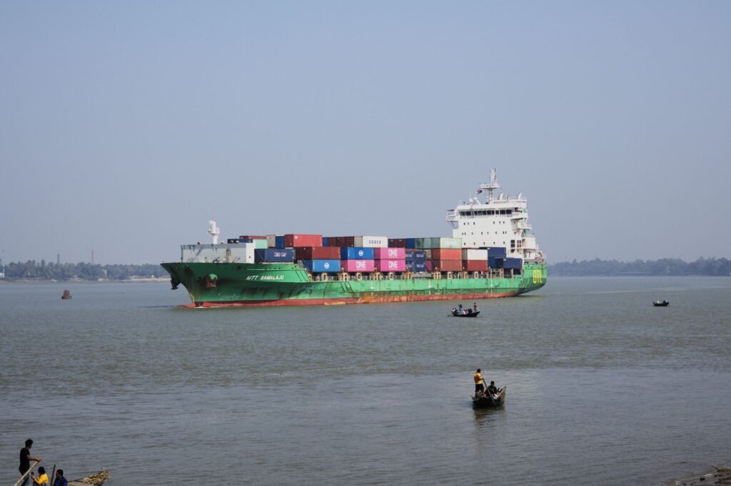 Thematic lead image: container ship riverbank — Hooghly River Incident Reveals Understated India Infrastructure Risk | National Times