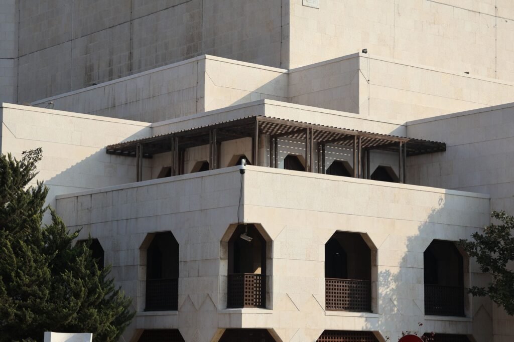 Thematic lead image: Syrian government building — Assad Cousin's Death Sentence Signals Power Consolidation | National Times