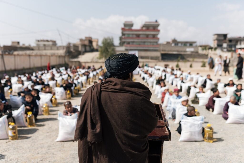 Thematic lead image: Taliban flags, UN vehicles — Taliban release of UN staff reveals internal divisions on foreign relations | National Times