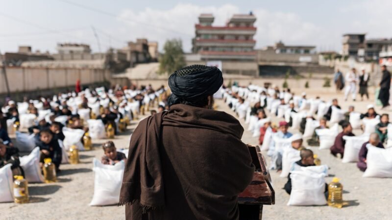 Thematic lead image: Taliban flags, UN vehicles — Taliban release of UN staff reveals internal divisions on foreign relations | National Times