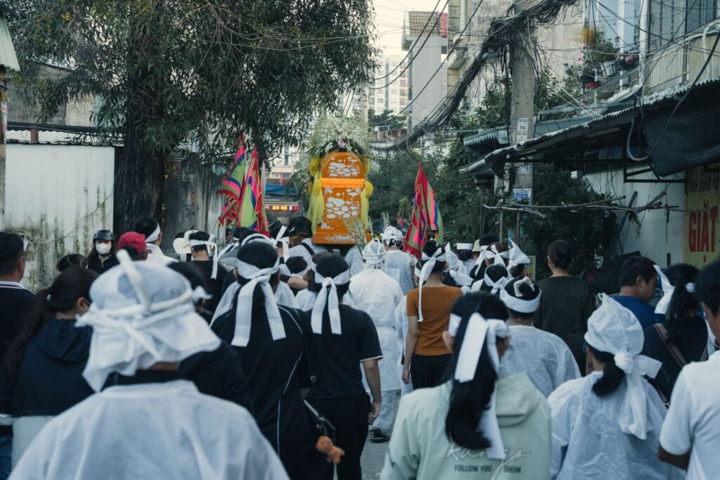 Thematic lead image: mass funeral procession — A Funeral for 112 Is Not One Event. It Is a Process Made Visible | National Times