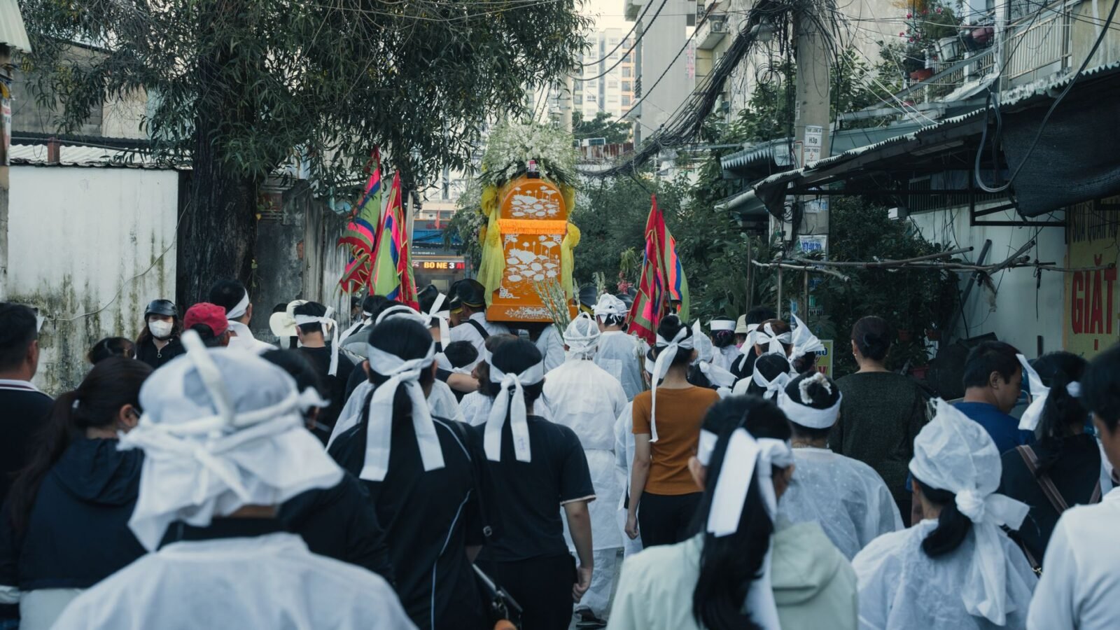 Thematic lead image: mass funeral procession — A Funeral for 112 Is Not One Event. It Is a Process Made Visible | National Times