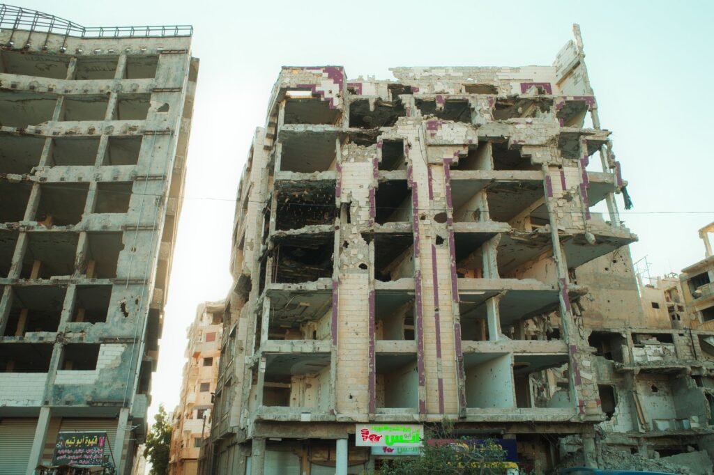 Thematic lead image: damaged buildings, Middle East conflict — Israel's Syrian Strikes Risk Wider Regional Confrontation | National Times