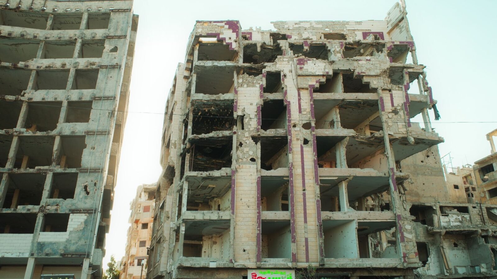 Thematic lead image: damaged buildings, Middle East conflict — Israel's Syrian Strikes Risk Wider Regional Confrontation | National Times