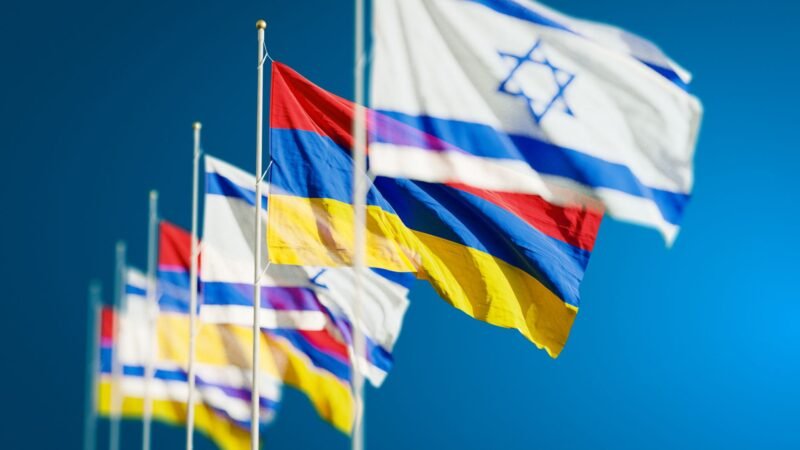 Thematic lead image: Syrian and Israeli flags, diplomatic discussion — Syria's Diplomatic Shift: A Strategic Rethink or Tactical Pause? | National Times