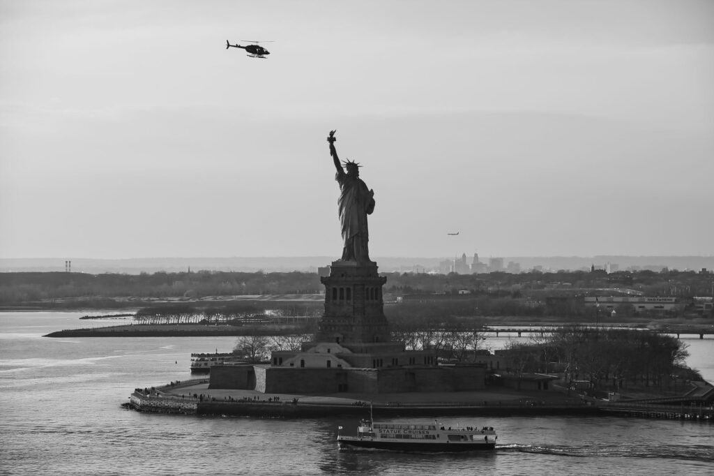 Thematic lead image: Statue of Liberty, capsized boat — Fatal Capsizing Near Statue of Liberty Tests US Asylum Policy | National Times