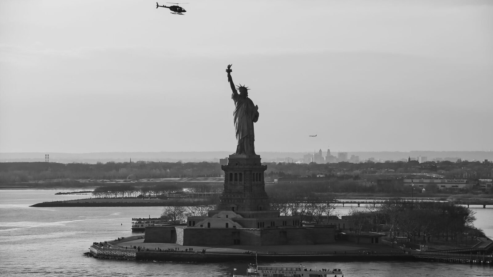 Thematic lead image: Statue of Liberty, capsized boat — Fatal Capsizing Near Statue of Liberty Tests US Asylum Policy | National Times