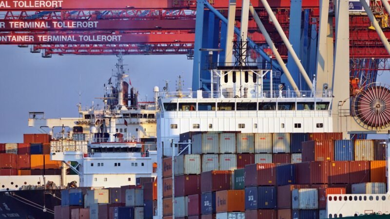 Thematic lead image: port, shipping, cityscape — UAE's Economic Resilience Tested Amid Hormuz Disruption | National Times