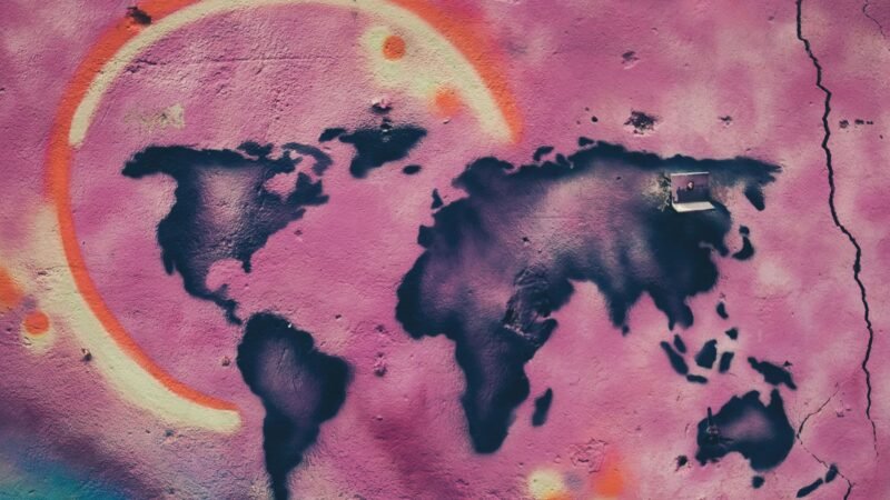 Thematic lead image: oil derricks, global map — IEA Demand Forecast Cut: The Understated Implications for Global Oil | National Times