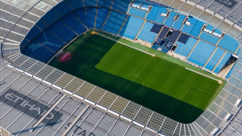 Thematic lead image: football stadium, city lights — Manchester Derby: A Microcosm of Football's Shifting Power Dynamics | National Times