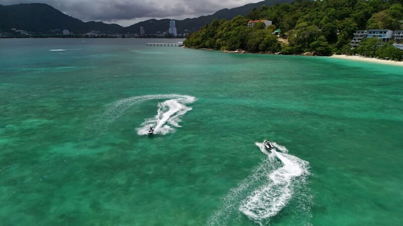 Thematic lead image: flooded street with jet ski — Bangkok Flood Response: Unsanctioned Act Divides Public Opinion | National Times