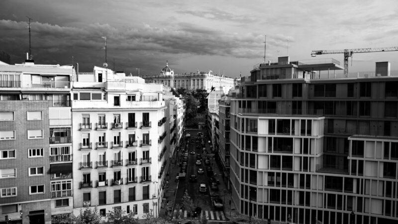 Thematic lead image: housing protest, urban landscape — Spain's Housing Crisis: Competing Pathways to 2030 | National Times