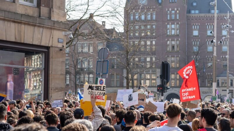 Thematic lead image: student protest crowd banners — French Student Protests Signal Deeper Political Discontent | National Times