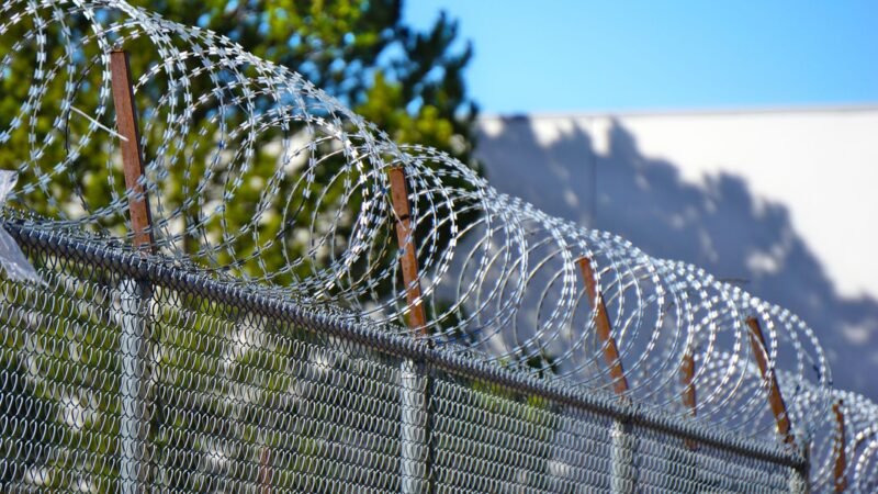 Thematic lead image: Military base perimeter fence — Latvian Arrests at RAF Molesworth Challenge UK Base Security Assumptions | National Times