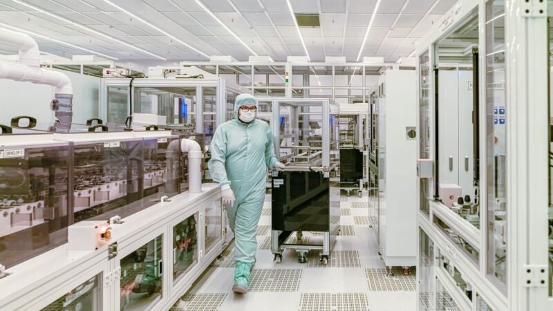 Thematic lead image: microchip fabrication plant — AI Infrastructure Demand May Insulate Asian Chipmakers from Big Tech Volatility | National Times